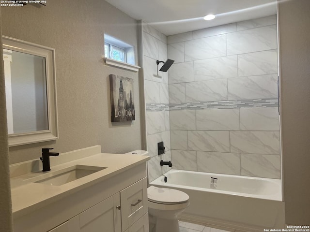 full bathroom with toilet, vanity, and tiled shower / bath