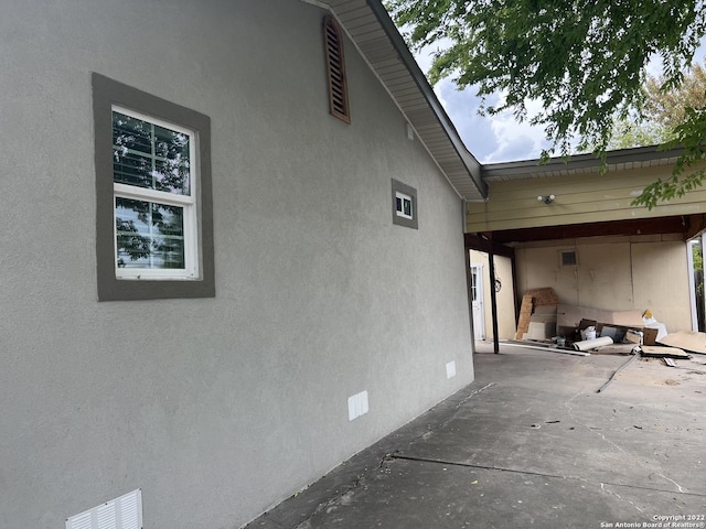 view of side of property with a patio