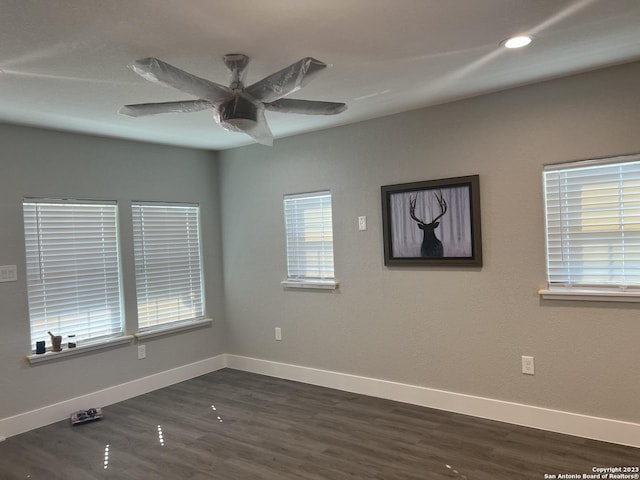 spare room featuring ceiling fan and dark wood-type flooring