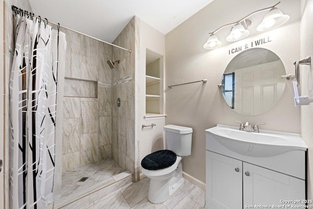 bathroom with vanity, curtained shower, and toilet