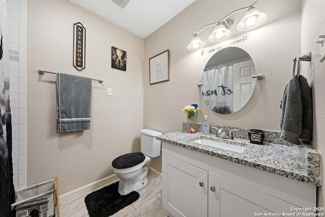 bathroom featuring vanity and toilet