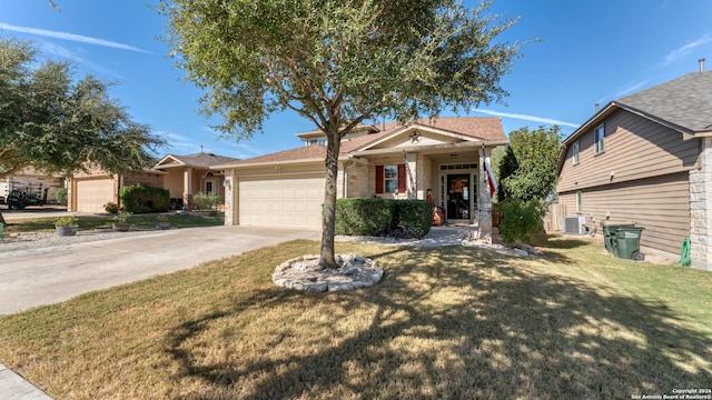 view of front facade with a front lawn, a garage, and cooling unit