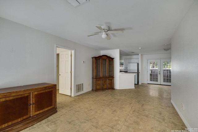 spare room with french doors and ceiling fan