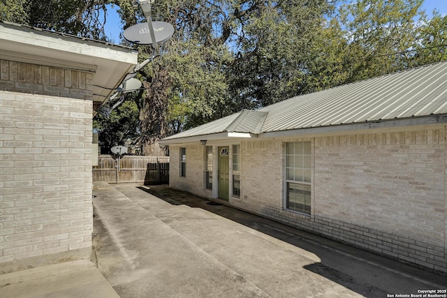 view of side of property with a patio area