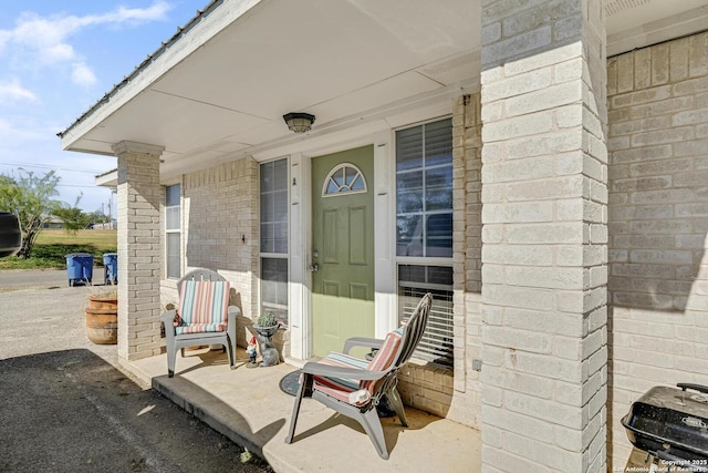 view of exterior entry featuring covered porch