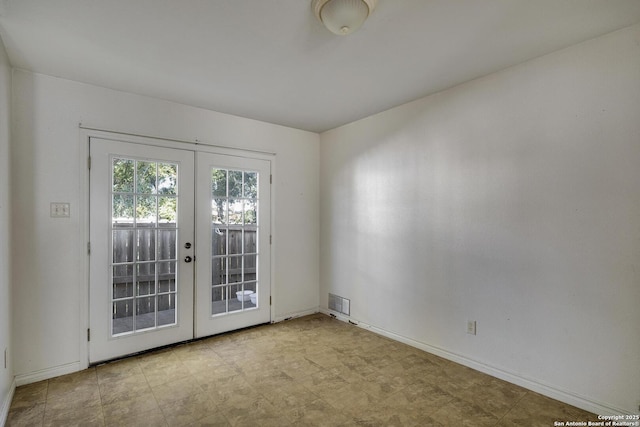 unfurnished room featuring french doors