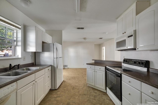 kitchen featuring white cabinetry, white appliances, and sink