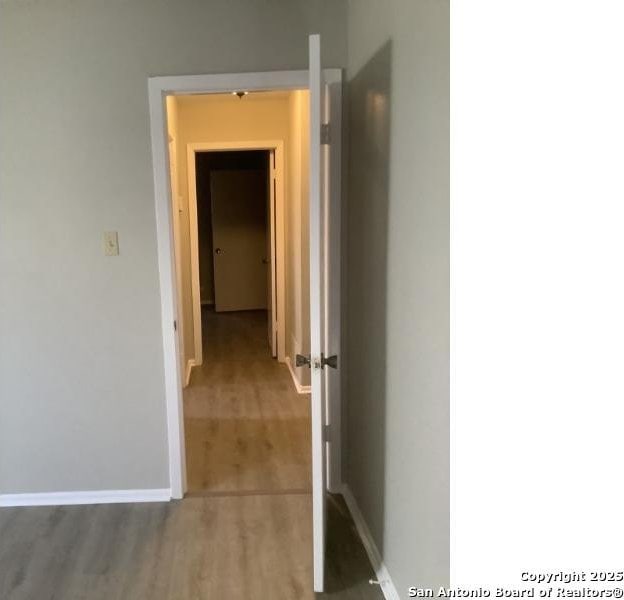 hallway with wood-type flooring