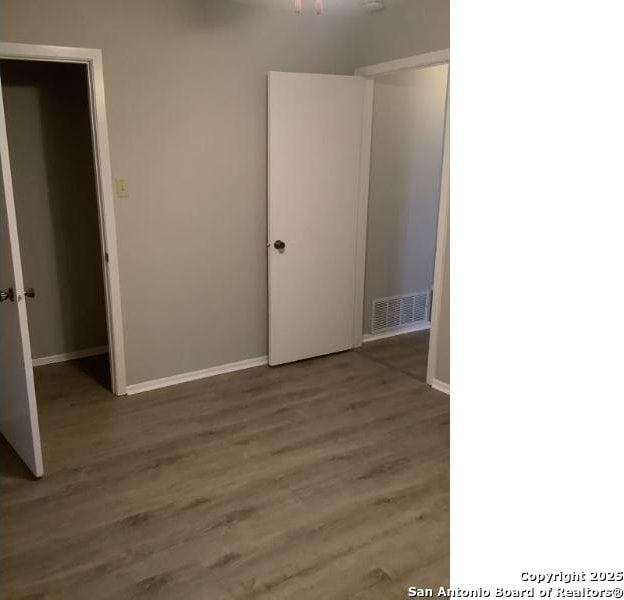 spare room with hardwood / wood-style floors