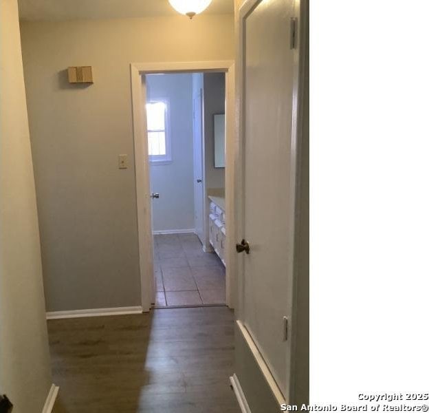 hallway with dark hardwood / wood-style floors