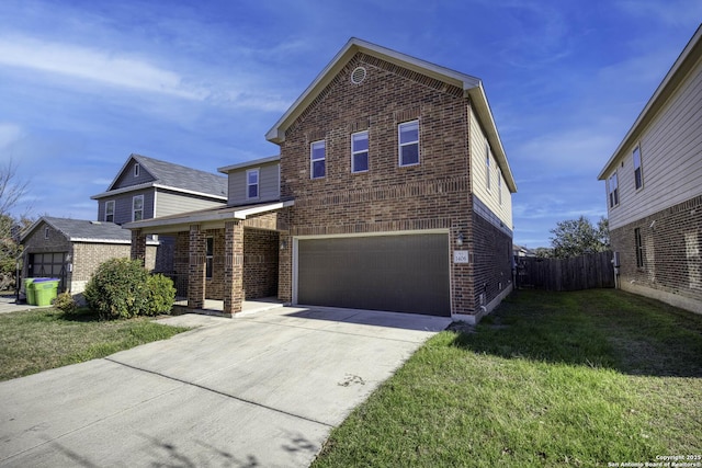 view of property featuring a garage and a front lawn