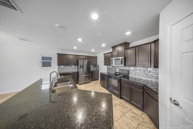 kitchen featuring sink, decorative backsplash, dark brown cabinets, light tile patterned flooring, and appliances with stainless steel finishes