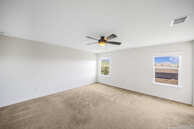 carpeted spare room with ceiling fan