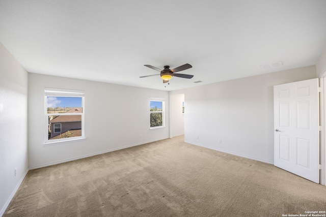 carpeted empty room featuring ceiling fan