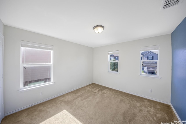 unfurnished room with light carpet