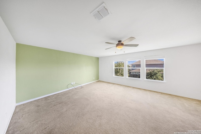 carpeted empty room featuring ceiling fan