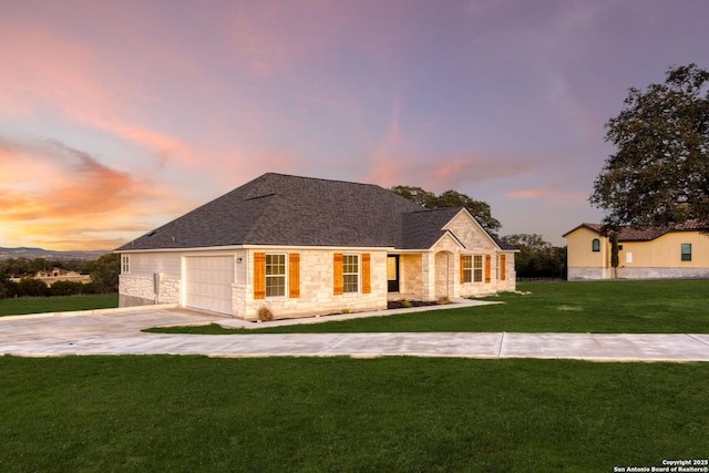 view of front facade with a yard and a garage