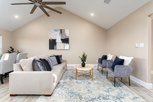 living room with ceiling fan, light hardwood / wood-style floors, and vaulted ceiling