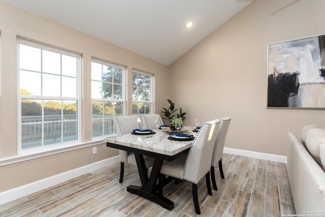 dining room featuring lofted ceiling