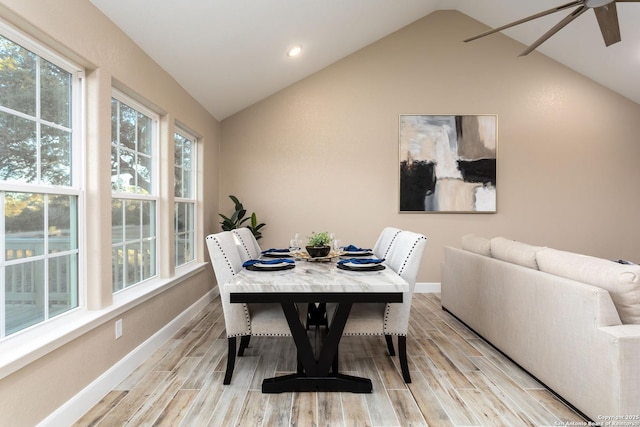 dining space with ceiling fan and lofted ceiling