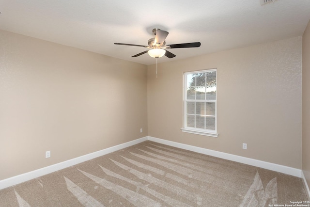 carpeted spare room with ceiling fan