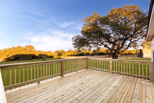 wooden deck with a lawn