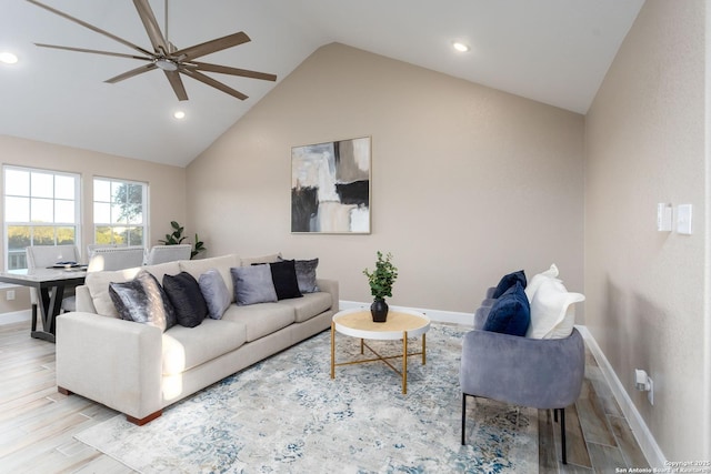 living room with ceiling fan, light hardwood / wood-style floors, and lofted ceiling