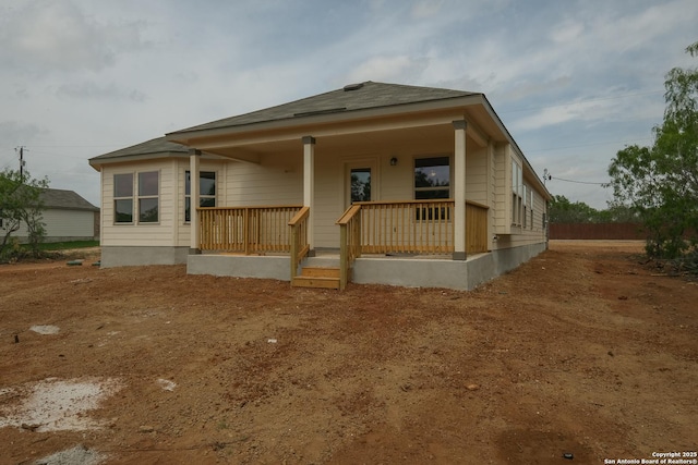 back of property with covered porch