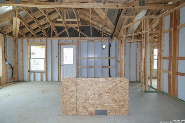 miscellaneous room with lofted ceiling