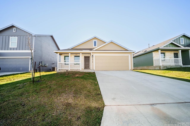 view of front facade with a front lawn, covered porch, and a garage