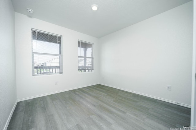 empty room with dark hardwood / wood-style floors