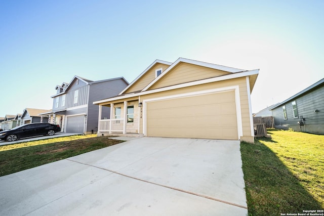 view of front of property with cooling unit, a front yard, and a garage