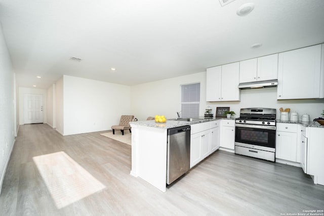 kitchen featuring light stone countertops, white cabinetry, and stainless steel appliances