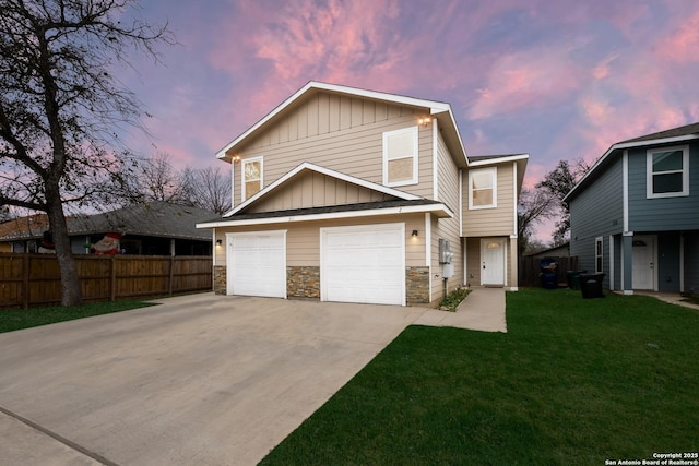 view of front of home with a yard and a garage