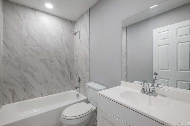 full bathroom featuring vanity, toilet, and tiled shower / bath