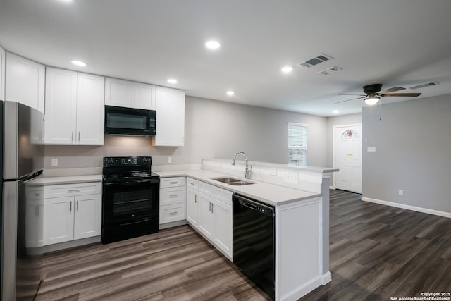 kitchen featuring black appliances, white cabinets, sink, dark hardwood / wood-style flooring, and kitchen peninsula