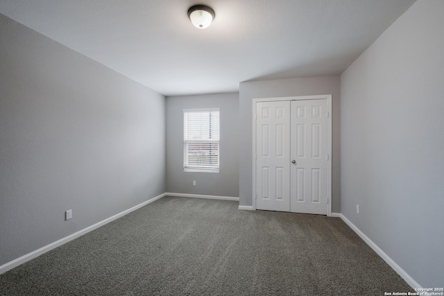 unfurnished bedroom with carpet and a closet