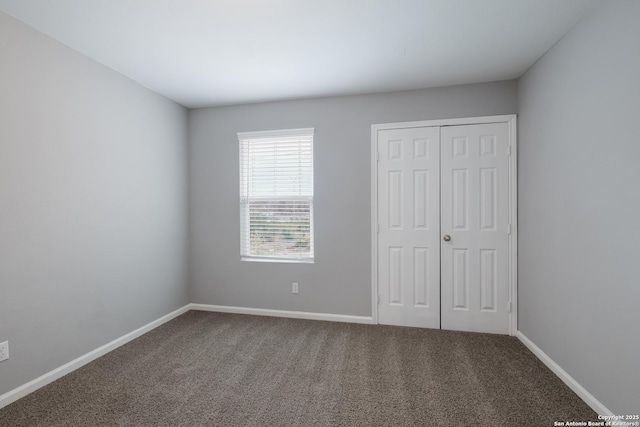 unfurnished bedroom with carpet floors and a closet