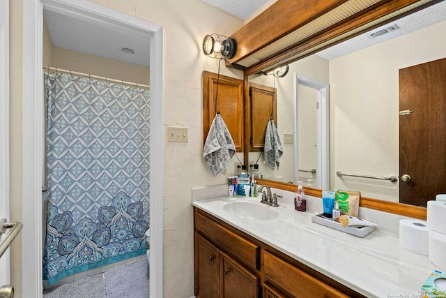 bathroom featuring vanity and a textured ceiling