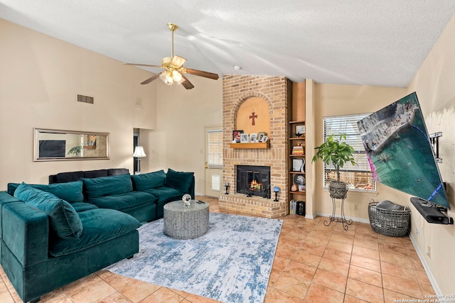 living room featuring ceiling fan, a brick fireplace, a textured ceiling, lofted ceiling, and light tile patterned flooring