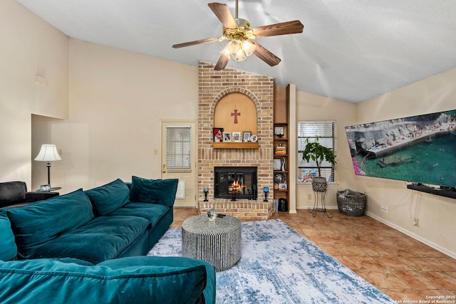 living room with a textured ceiling, ceiling fan, a fireplace, lofted ceiling, and light tile patterned flooring