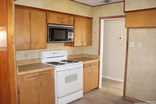 kitchen featuring light hardwood / wood-style floors and white gas stove