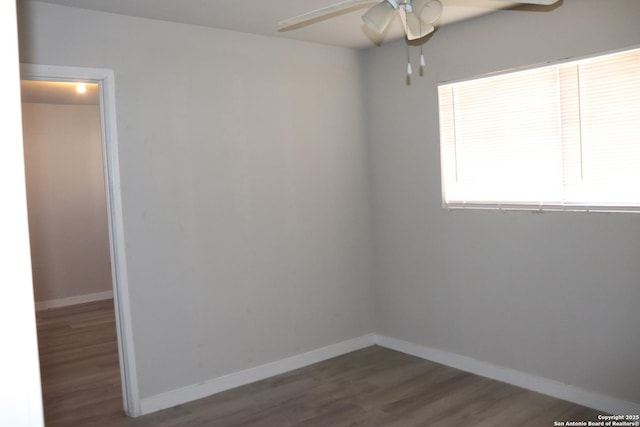 spare room featuring dark hardwood / wood-style floors and ceiling fan