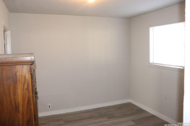 empty room featuring dark hardwood / wood-style flooring