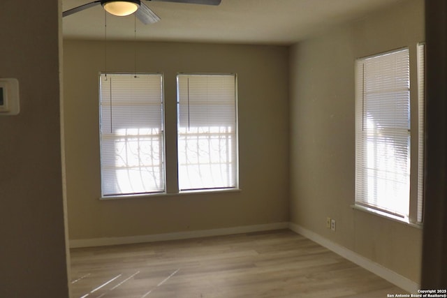 spare room with ceiling fan and light wood-type flooring