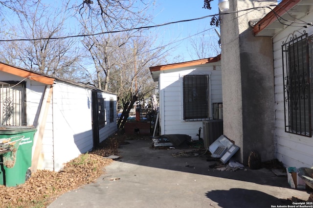 view of side of property featuring central AC