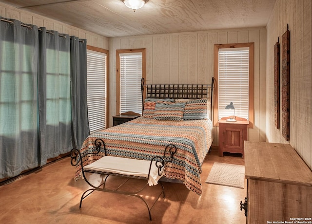 bedroom featuring wooden walls