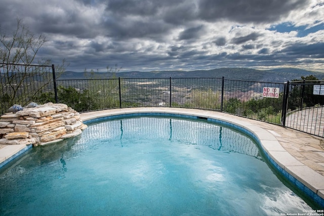 view of pool with a mountain view