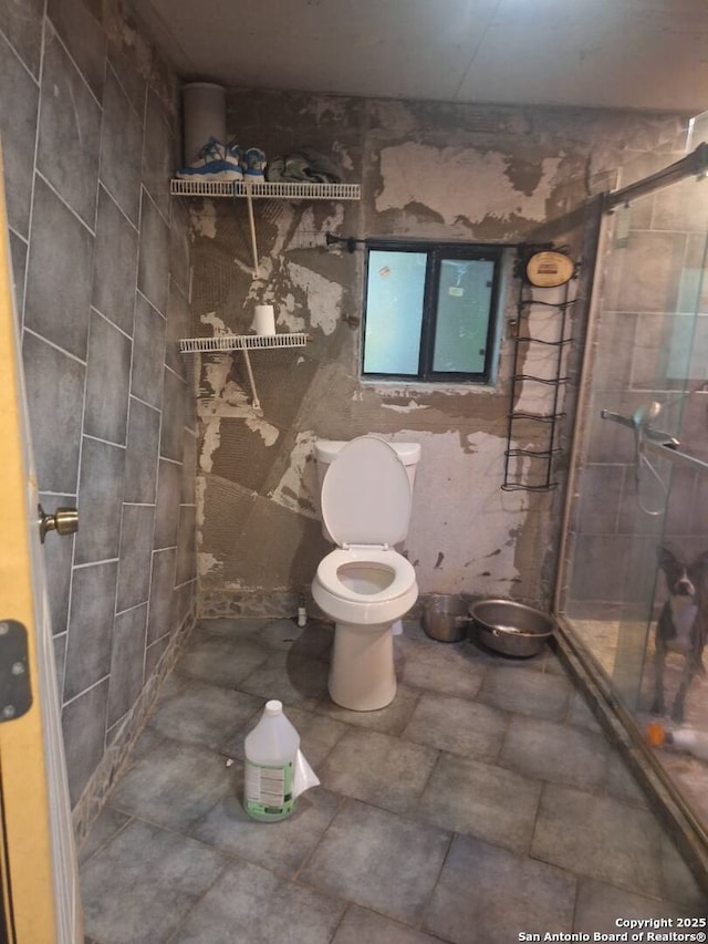 bathroom with tiled shower and toilet