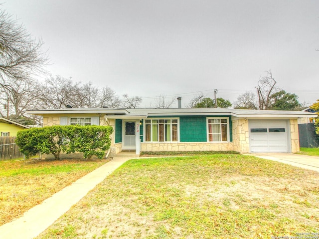 ranch-style home with a front yard and a garage